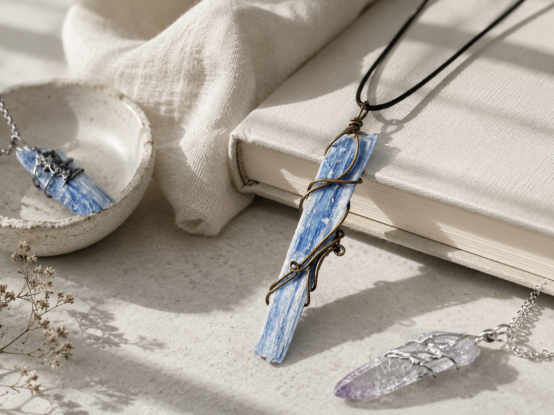 Handcrafted crystal necklaces styled on linen and stone to represent alignment, inner peace, and emotional balance