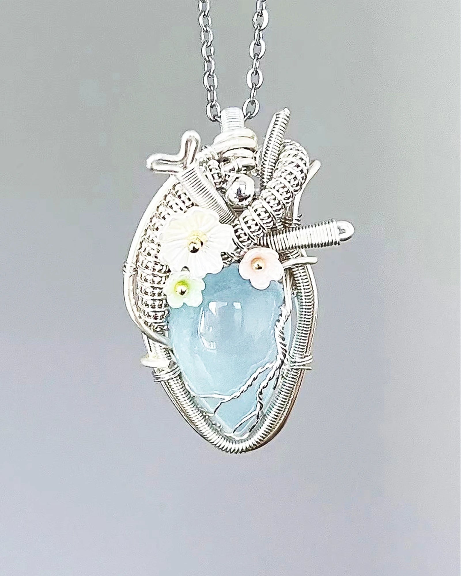 Handmade aquamarine crystal heart wire wrapped necklace with natural blue crystal pendant, symbolizing flow, clarity, and gentle emotional healing.