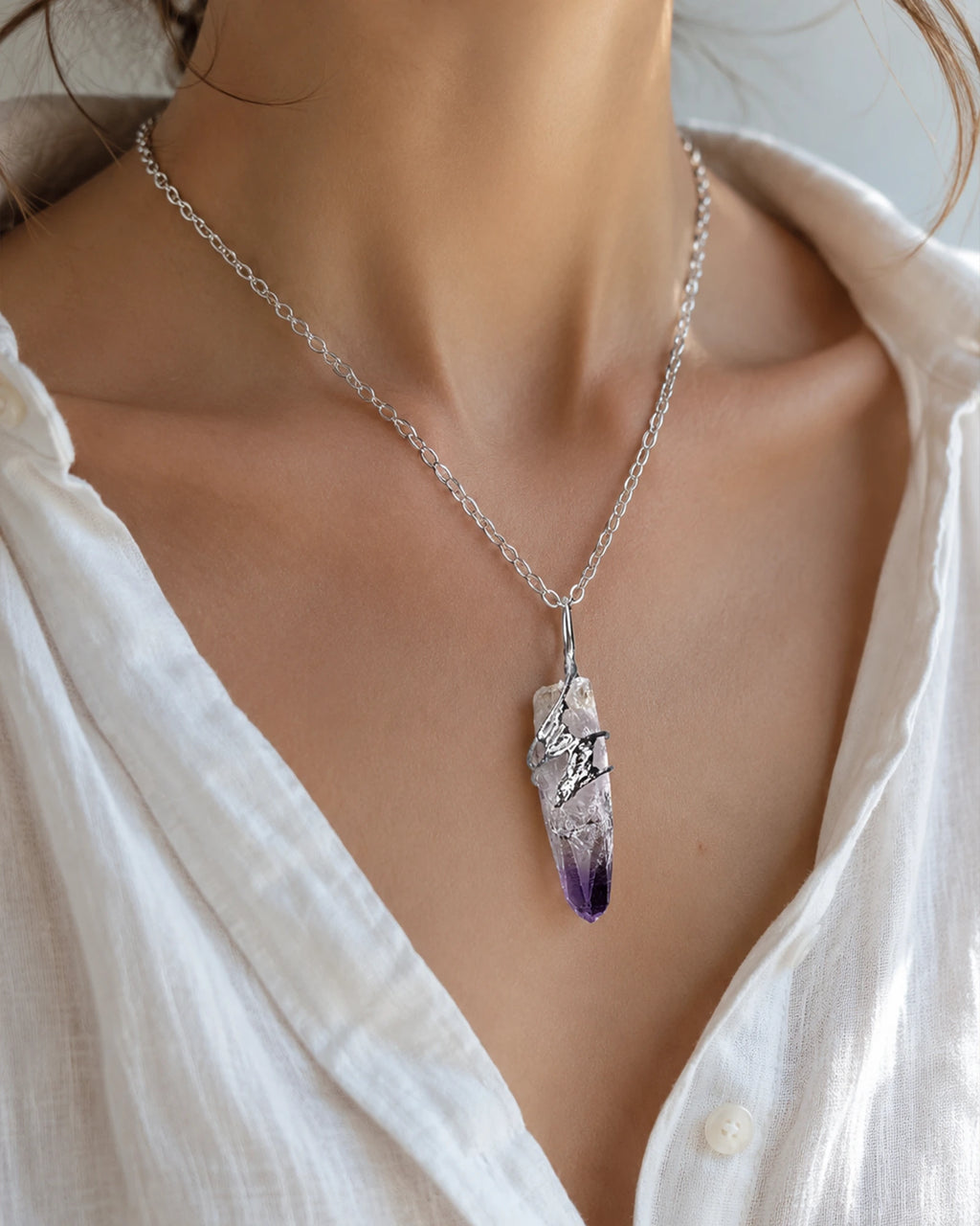 Woman wearing a handmade Cruz amethyst soldered pendant necklace, styled as meaningful crystal jewelry for intuition and inner peace.