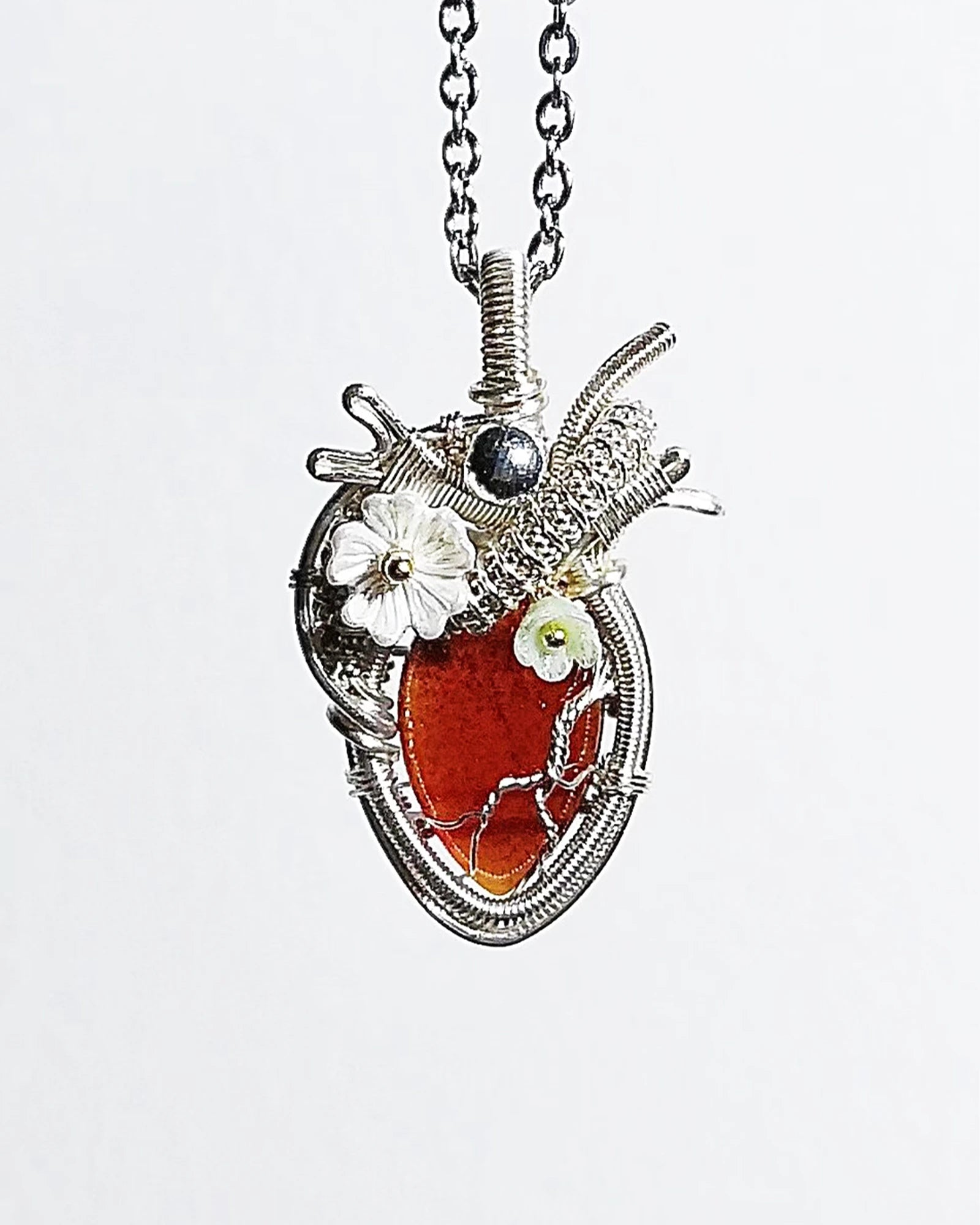 Handmade garnet crystal heart wire wrapped necklace with natural red crystal pendant, symbolizing passion, strength, love, and emotional healing.