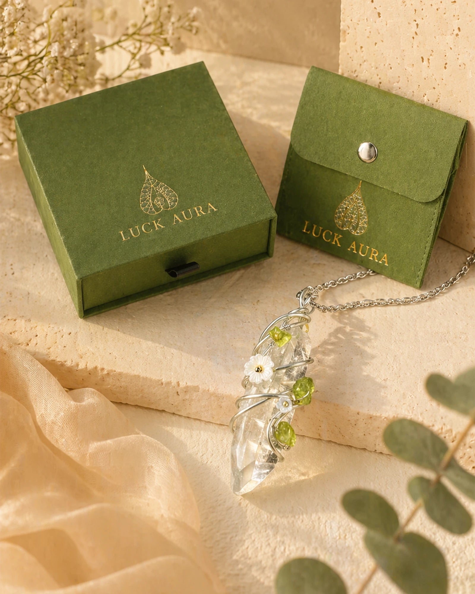 Handmade clear quartz garden wire wrapped necklace displayed with LuckAura gift packaging, dried flowers, and soft natural light as a meaningful jewelry gift.