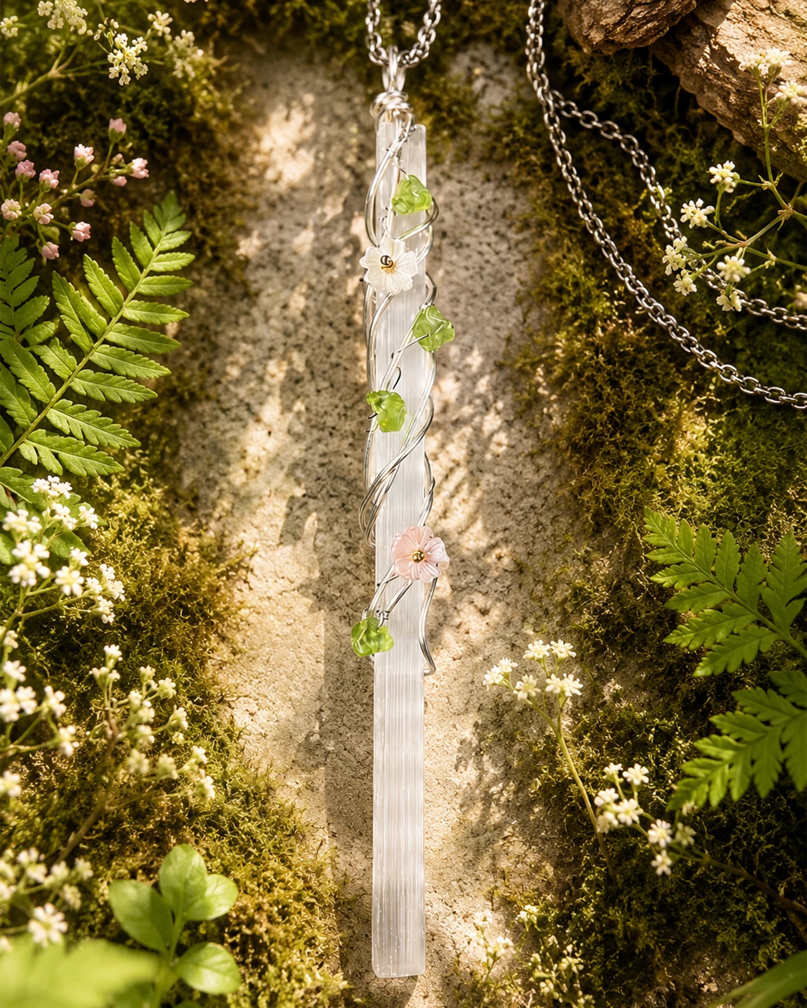 Selenite garden wire wrapped necklace styled in a calm natural setting with soft light, botanical details, and peaceful handmade crystal jewelry aesthetic.