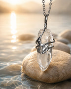 Handmade clear quartz necklace placed in natural sunlight as a symbolic piece for clarity and calm energy.