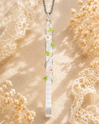 Handmade selenite garden wire wrapped necklace with natural crystal pendant and floral details, symbolizing clarity and peaceful energy.