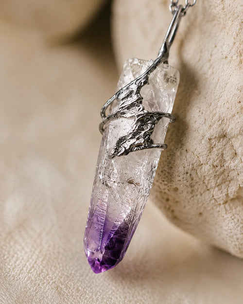 Close-up of handmade Cruz amethyst soldered pendant showing natural crystal texture, silver-toned soldered details, and one-of-a-kind craftsmanship.