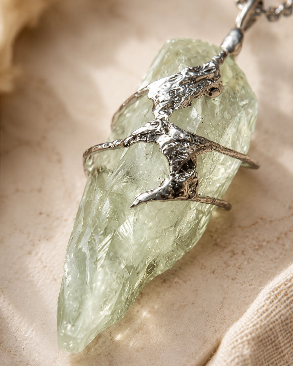 Close-up of handmade green crystal soldered pendant showing natural crystal texture, silver-toned soldered details, and one-of-a-kind craftsmanship.
