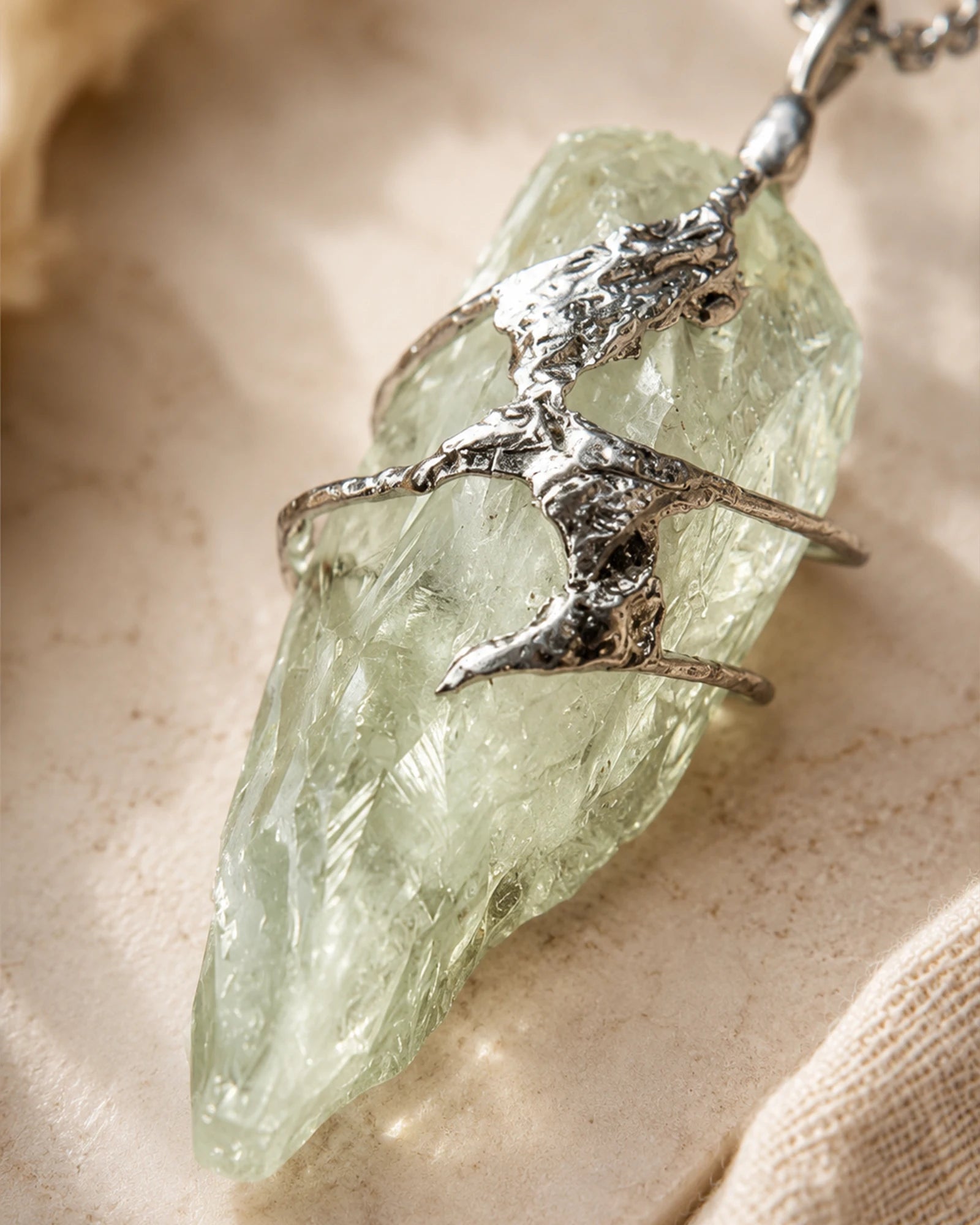 Close-up of handmade green crystal soldered pendant showing natural crystal texture, silver-toned soldered details, and one-of-a-kind craftsmanship.