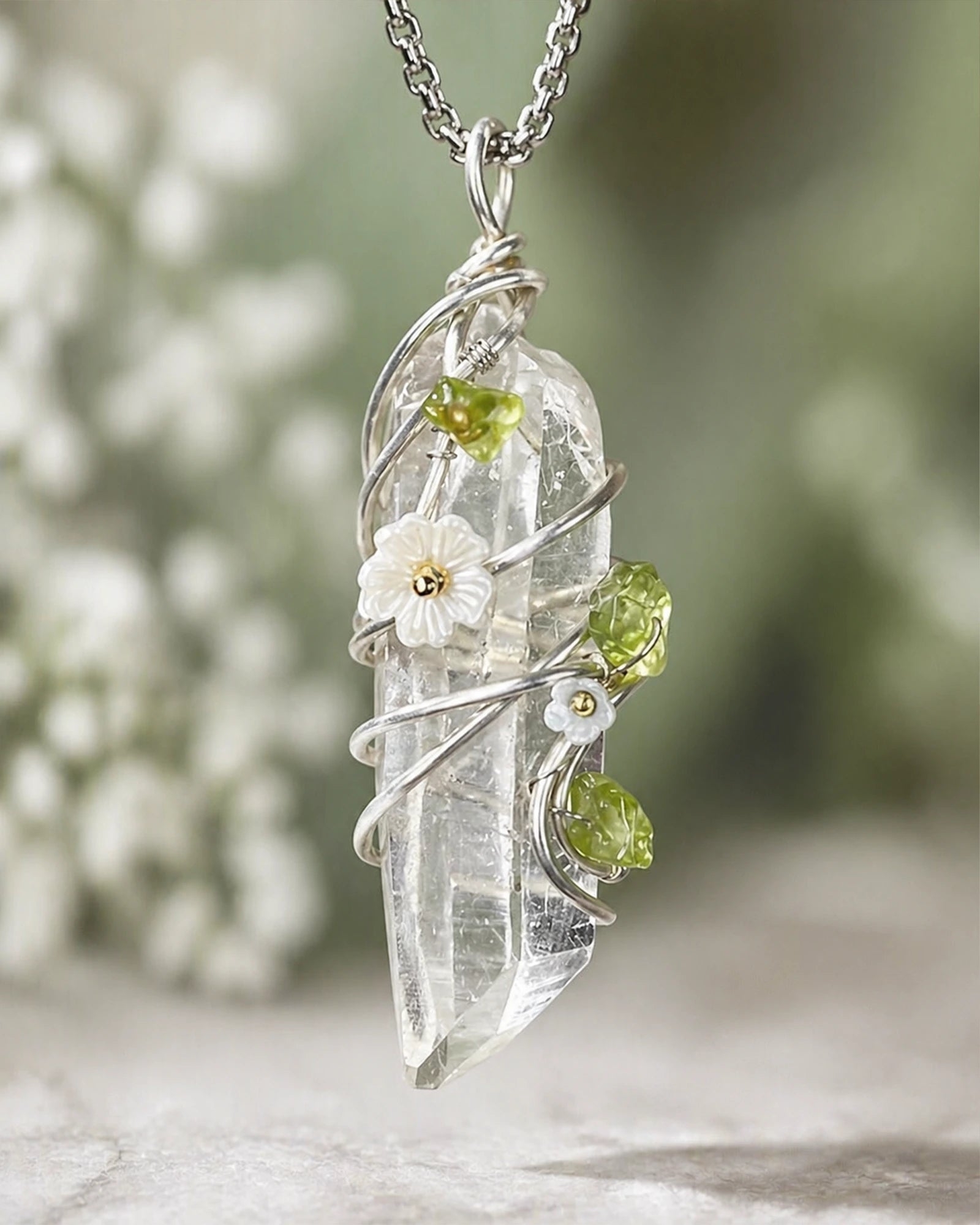 Close-up of handmade clear quartz garden wire wrapped pendant showing natural crystal texture, delicate wire wrapping, and floral accent details.