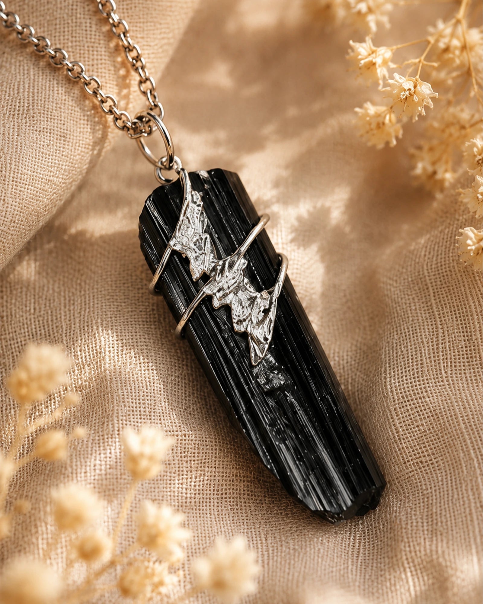 Close-up of handmade black tourmaline soldered pendant showing natural crystal texture, silver-toned soldered details, and one-of-a-kind craftsmanship.