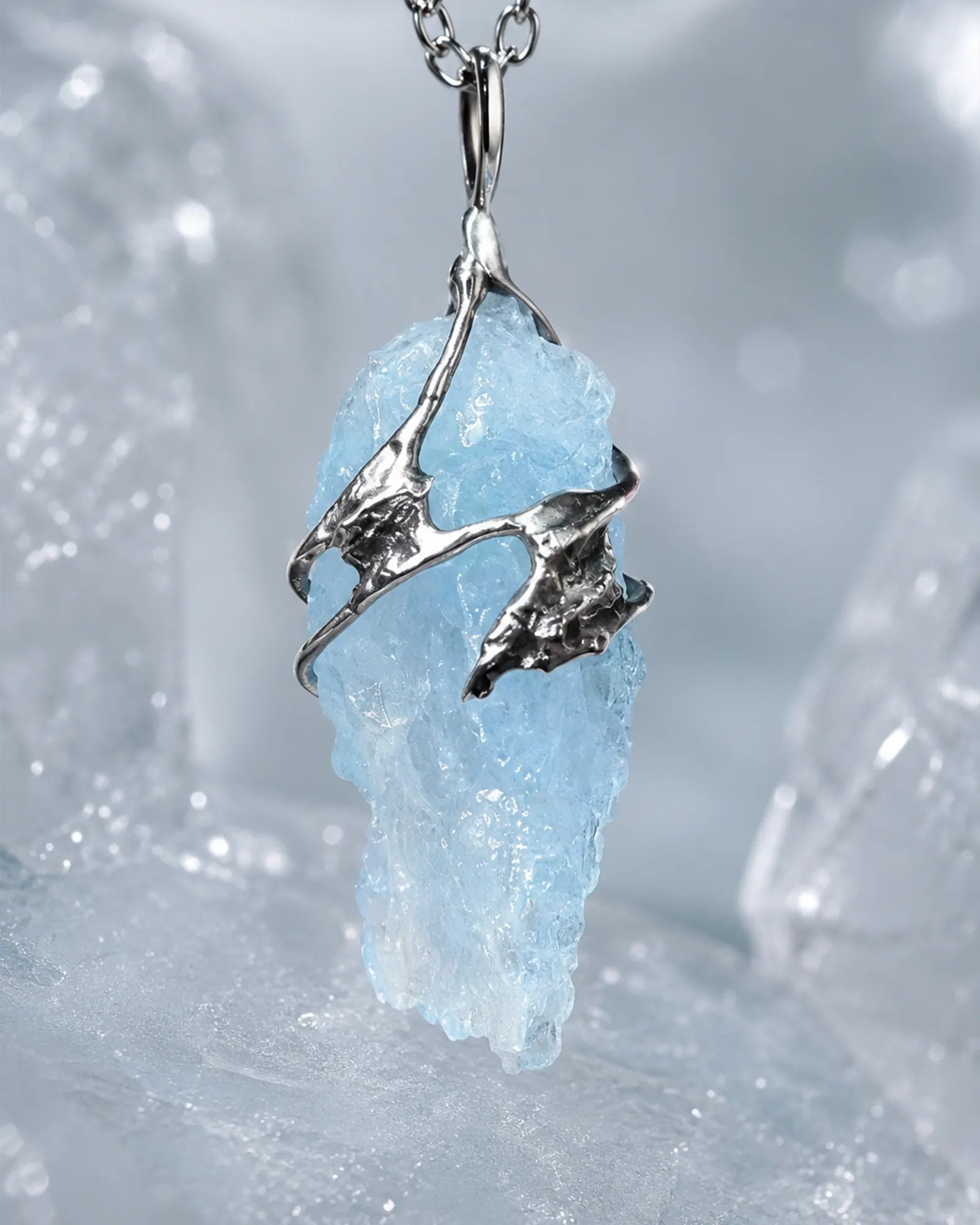 Close-up of handmade glacial blue crystal pendant showing natural crystal texture, silver-toned details, and one-of-a-kind craftsmanship.
