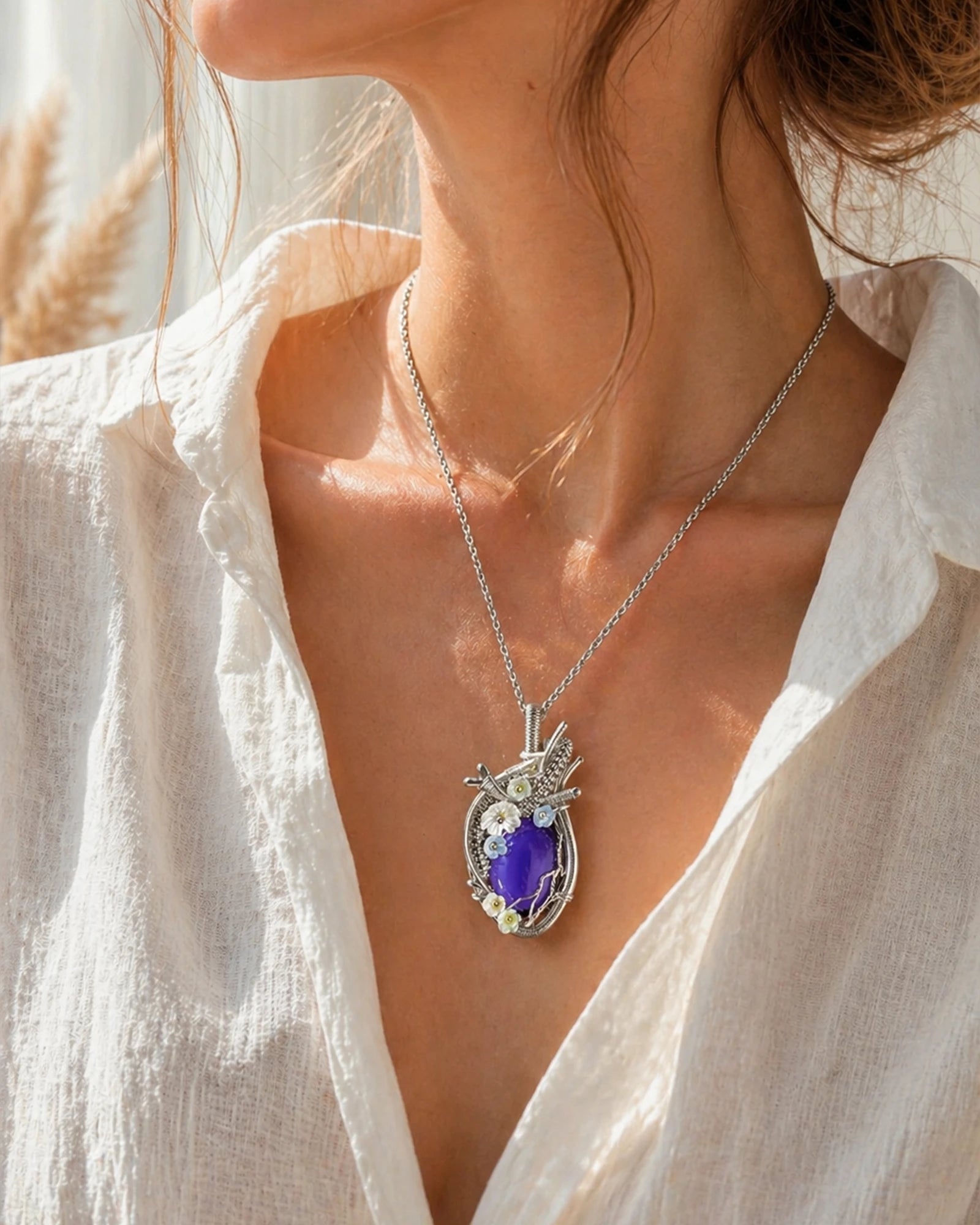 Woman wearing a handmade crystal heart wire wrapped necklace, styled as meaningful crystal jewelry for love and emotional healing.