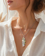 Woman wearing a handmade clear quartz garden wire wrapped necklace, styled as meaningful crystal jewelry for clarity and spiritual growth.