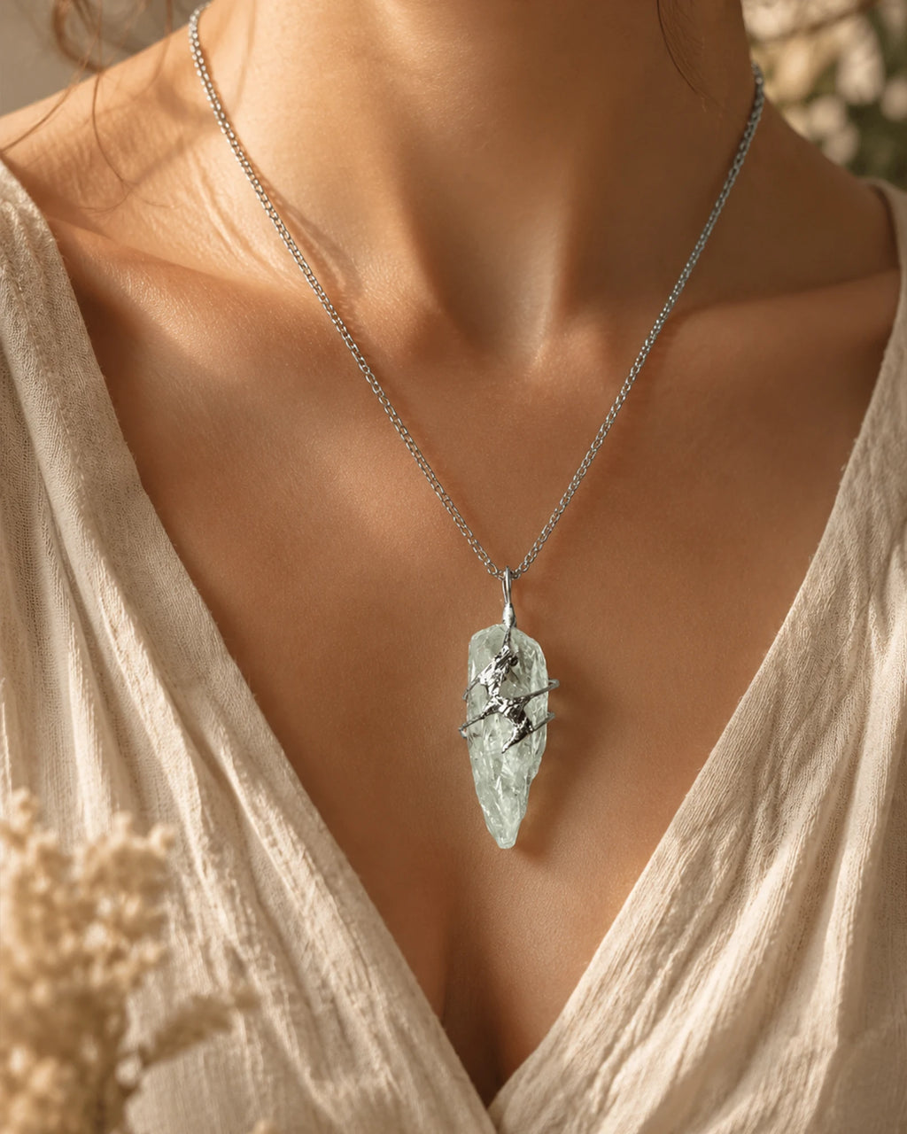 Woman wearing a handmade green crystal soldered pendant necklace, styled as meaningful crystal jewelry for growth, renewal, and abundance.