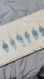 Video showing a handmade clear quartz soldered pendant necklace in natural light, with crystal texture, silver-tone details, and a calm clarity-inspired design.